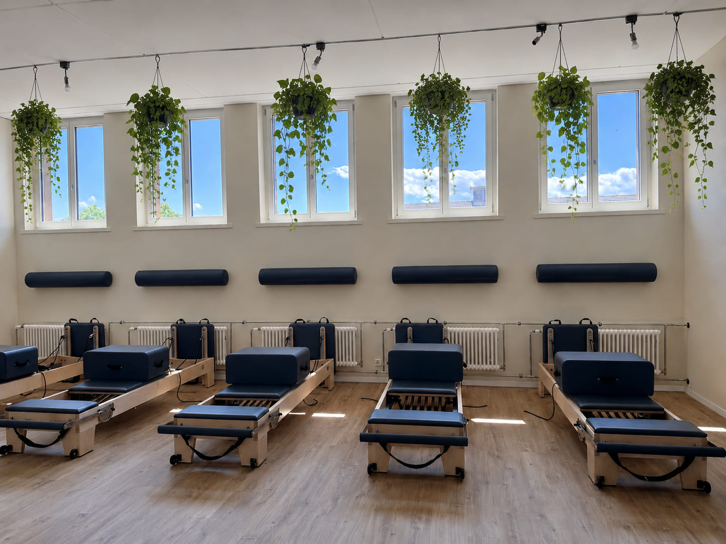 The Élan Pilates studio in Langenthal with reformer equipment set up in warm daylight.